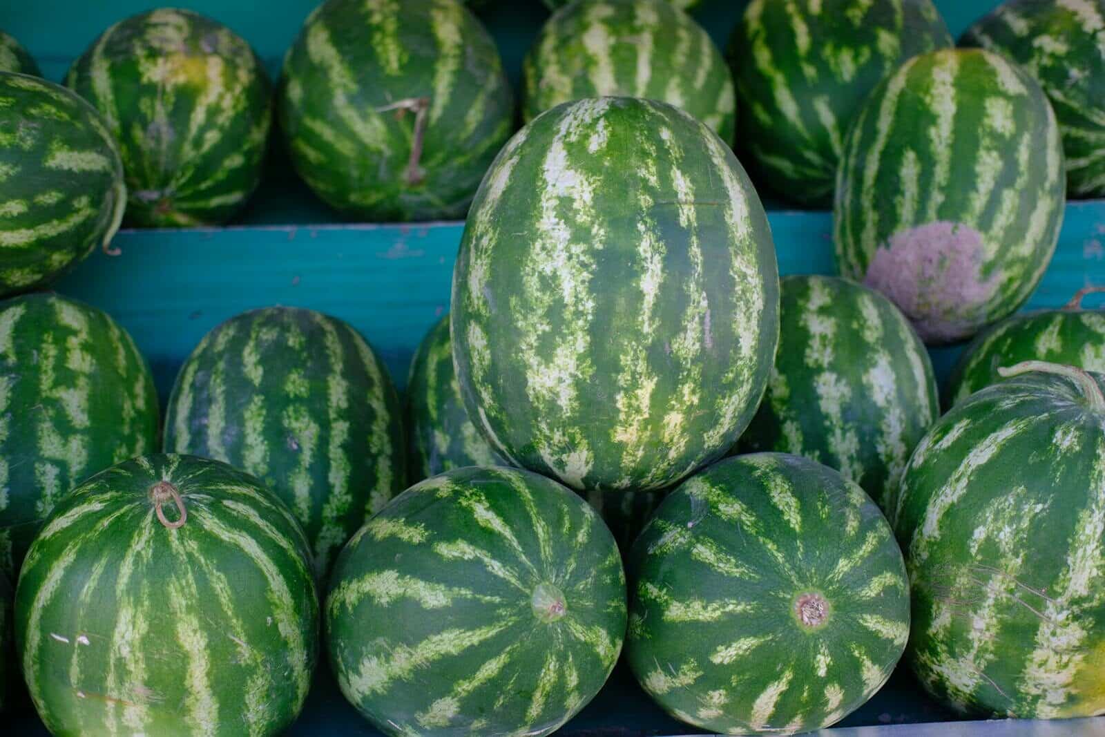 Fresh green watermelons on display at a local market in İzmir, Türkiye.